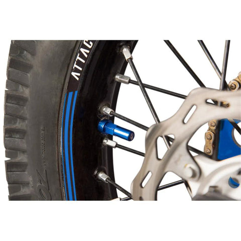 Tusk blue rim lock nut spacer kit installed on motorcycle wheel with disc brake rotor.