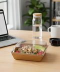 Brown charcuterie box with clear lid on desk with laptop, salad inside. 100 Pack Charcuterie Boxes With Clear Lids, 5.4 By 5 By 2.5 Inches