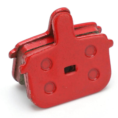 Close-up view of a red semi-metallic disc brake pad, part of the Eight Pack SemiMetallic Disc Brake Pads For Mountain And Electric Bikes Durable Low Noise High Heat Resistant Bicycle Brake Pad Replacement Set For Smooth Stops And Long Life.