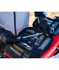 Person holding tools from Compact Trail Saver Motorcycle Tool Kit With Axle Wrench 22mm And 27mm Puncture Repair Kit Quality CRV Hand Tools Durable Zippers Lifetime Warranty Replacement Items Available Great For Yamaha YZ250 YZ250F YZ250X YZ450FX Adventures on motorcycle seat