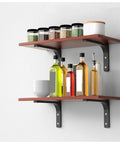 Heavy Duty L Shaped Corner Wall Mount Shelf Brackets With Thickened Steel Build For Floating Industrial Storage That Handle Load Like No Sweat And Bring Major Clean Vibes To Your Space In Black supporting wooden shelves with bottles and jars.