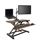 Vari Pro Plus 36 Electric Standing Desk Converter In Stylish Walnut Finish with dual monitors setup and ergonomic design.