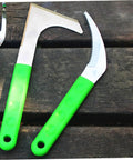Two-Piece Stainless Steel Garden Scythe Set For Weeding And Grass Cutting With Ergonomic Non-Slip Handle on wooden surface