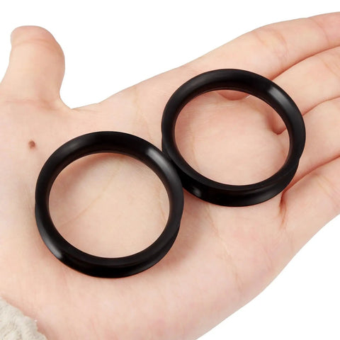 Hand holding 38mm Black Silicone Ear Gauges Tunnels Plugs Kit Soft Flexible Rubber Double Flared Saddle Retainer For Piercing Jewelry