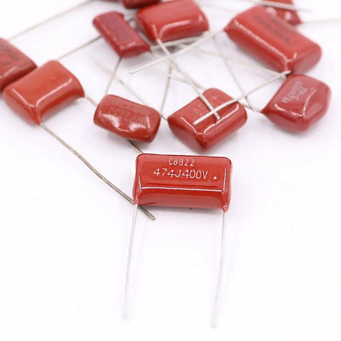Close-up of 150 Piece CBB Metallized Polypropylene Film Capacitor Kit 400V-630V Range 10nF To 68nF, showing red radial leads.