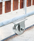Knockout 4 Inch Galvanized Steel V Groove Gate Wheel With Welded Bracket Handles 3000 Pounds Loaded Down Hard With Premium Sealed Bearings To Roll Open Heavy Barn Doors Without Breaking A Sweat Ever, mounted on sliding gate.