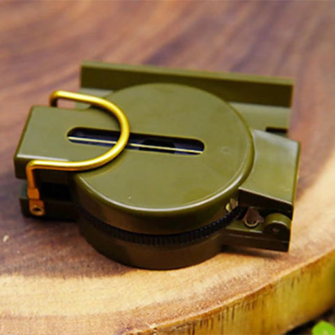 Durable Wilderness Survival Compass for Orienteering and Outdoor Navigation, folded on wood, plastomer with floating dial