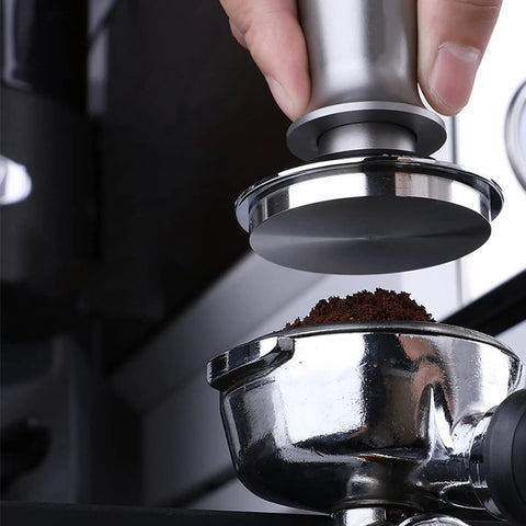 Top-Tier Coffee Tamping Station With Built-In Espresso Knock Box And Portafilter Holder Keeps Your Bar Setup Crisp Fits 58mm Portafilters, showing a hand using a metal tamper on coffee grounds in a portafilter.