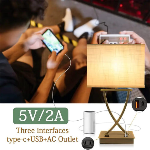 3-Way Dimmable Touch Table Lamp With USB C Port And AC Outlet, white shade beside charging devices, ideal for bedroom or office