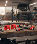Pair Front Sway Bar Stabilizer Links For Ford Explorer Mountaineer Ranger Ram 1998 1999 2000 2001 2002 2003 2004 2005 29.5mm Bar With USA Made Bushings Rugged Heavy Duty Upgrade, red bushings and black links on workbench