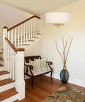 4 Light Gold Modern Drum Chandelier With White Linen Shade 17.7 Inch Pendant Light Fixture in stylish foyer setting.
