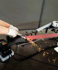 Badass 2X72 Inch Variable Speed Belt Sander And Multi Angle Vertical Horizontal Grinder For Knife Polishing With Three Abrasive Wheels And Rock Solid Base 110V 2840 RPM Shop Staple in action polishing a blade.