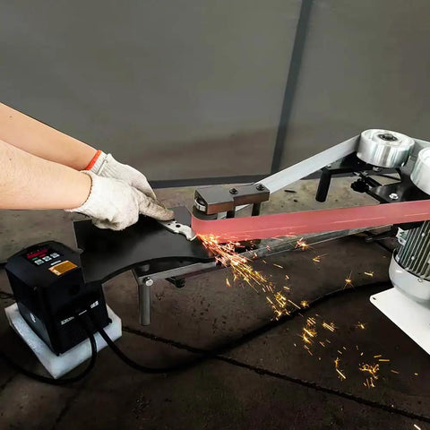 Badass 2X72 Inch Variable Speed Belt Sander And Multi Angle Vertical Horizontal Grinder For Knife Polishing With Three Abrasive Wheels And Rock Solid Base 110V 2840 RPM Shop Staple in action polishing a blade.
