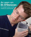 Easy Water Rinse Ear Wax Removal Kit With 3 Quad Stream Tips in use by person with glasses and container.