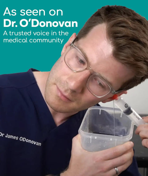 Easy Water Rinse Ear Wax Removal Kit With 3 Quad Stream Tips in use by person with glasses and container.