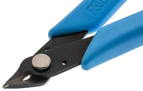 Close-up of Pro Grade Micro Shear Flush Cutter 18 AWG Capacity Five Inch Overall Length Alloy Steel Construction Great For Electronics Jewelry Making And Craft Solder Work with blue grips.