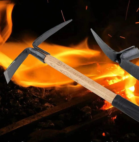 Small Hand Held Garden Pick Mattock For Weeding And Cultivation with wooden handle, steel construction in front of flames.