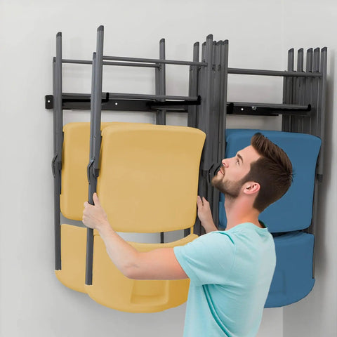 Man using 2 Pack Folding Chair Storage Rack Wall Mount Hangers for garage organization with yellow and blue chairs