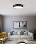 Living room with Slick Modern Black Wood Look Flush Mount Ceiling Light 3 Light Fixture, round and dimmable, no bulbs included.