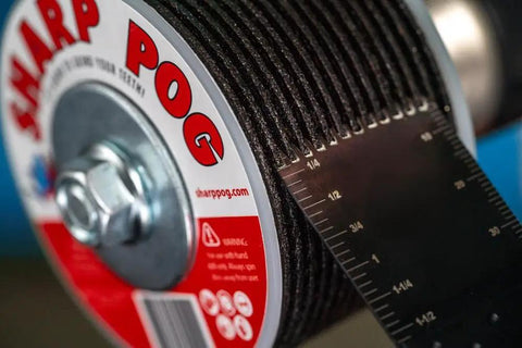 Close-up of Oscillating Saw And Multitool Blade Sharpener For Dull Blades Red Grip Quick Sharpening Tool showing measurement markings