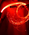 Person holding Lit Fiber Optic Space Dancing Light Whip with Rechargeable LED, 5.9Ft Rave Toy in glowing red, 360 degree swivel visible.