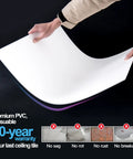 Person holding a 24 Pack Smooth Drop Ceiling Tiles 2x2 Feet Premium PVC Panels showing flexibility and durability, no sag or breakage.