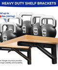 Heavy duty 2 Pack 10 Inch Black Folding Shelf Brackets holding kettlebells, showcasing wall mount installation and steel support.