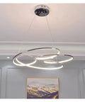Slick Minimalist Iron Pendant Light For Kitchen And Office With Warm Led Bulb Large 74 Cm Wide Chrome And Gold Finish Contemporary Ceiling Lamp hanging over a dining area.