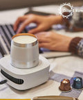 Keep Your Morning Sip Hit The Spot With This Versatile Travel Coffee Mug Warmer That Heats Or Chills Drinks Quickly Ideal For Commutes Desk Work And Home Offices, showing a mug on a warmer at a desk.