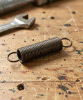 Heavy Duty Two Pack Hook Extension Springs For Recliner Chair Repair Solid Black Steel DIY Furniture Fix on wooden surface.