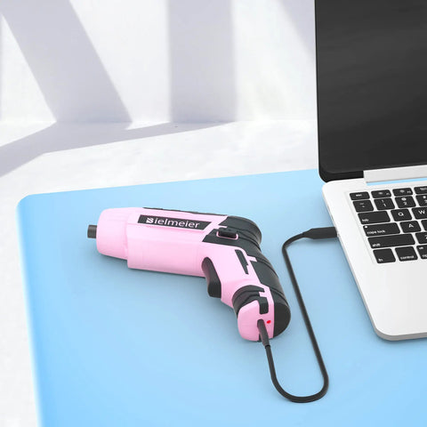 Pink Cordless Screwdriver Set With Automatic Torque Control And Sensor connected to laptop for charging