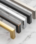 Oil Rubbed Bronze Solid Square Bar Cabinet Handle Pull 3 Inch Center To Center 25 Pack in mixed metal finishes on marble surface