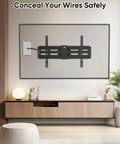 Slick Flexible Rubber Wall Grommet Kit For Hassle Free Low Voltage Cable Routing Behind TV And Game Console Smooth Install No Drama Neat Media Setup Two Piece Off White, installed behind a TV for wire concealment.