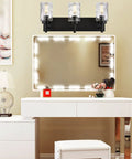 Three Light Modern Vanity Wall Sconce In Black With Hammered Glass Shades above illuminated mirror in dressing table setup