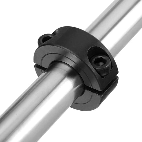 Double-split shaft collar clamped around a silver steel shaft; black clamp with two M4 set screws visible