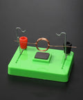 Electric Motor Model And Electromagnetic Swing Kit For Classroom Learning on green base with copper coil highlighting electromagnetism.