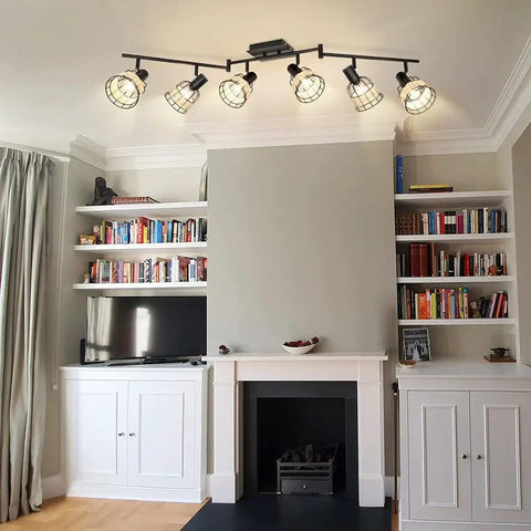 Six Light Bamboo LED Track Lighting Kit With Rattan Cage Industrial Ceiling Spotlight above a fireplace in a cozy living room.