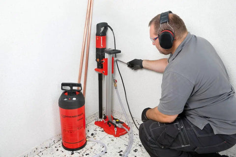 Heavy Duty Diamond Drill Motor With Three Speed Gearbox Tough As Nails For Wet And Dry Core Drilling in use with safety gloves.