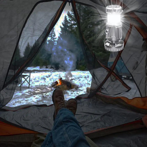 Camping scene with Two Pack Solar Camping Lantern With Fan For Outdoors, Three Way Power Source Solar USB Rechargeable Or AA Battery Backup.