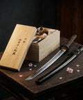 All In One Blade Cleaning And Maintenance Kit For Japanese Sword Care with choji oil, uchiko ball, and more on wooden table.