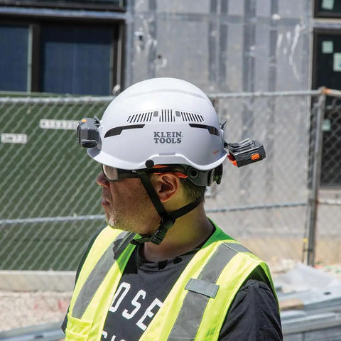 Worker wearing a hard hat equipped with a rechargeable portable cooling turbo fan for hard hats and safety helmets quiet 3-speed.