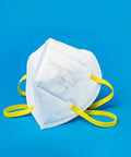 N95 Foldable Mask Pack USA Made NIOSH Approved 20 Count with white dome shape and yellow bands against blue background
