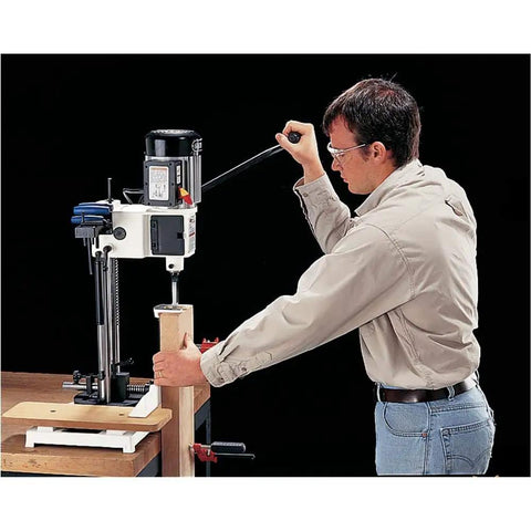 User operating the Badass Built Rock Solid Three Quarter Horsepower Heavy Duty Benchtop Mortising Machine on wood.