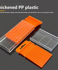 Orange Plastic Drill Bits Storage Box With Pull Out Design on dark surface, showcasing clear cover and orange tray insert.