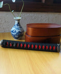 Dope DIY Tsuka Sword Handle Kit Ten Point Two Inch for Samurai Katana with red and black silk Ito wrap on wooden table
