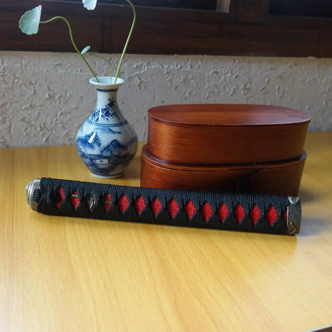 Dope DIY Tsuka Sword Handle Kit Ten Point Two Inch for Samurai Katana with red and black silk Ito wrap on wooden table