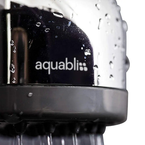 Close-up of TurboSpa 3 Inch High Pressure Shower Head with 42 Nozzles, ultra wide spray visible, focus on metal finish and water droplets.