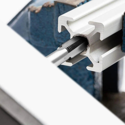 Close-up of M18 X 1.5 Hand Tap Set For Metalworking Right Hand HSS Threading Tool inserted in metal for threading