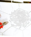 100 Pcs Nylon Hidden Fasteners And Double Headed Furniture Connectors on a tile surface with pliers, ideal for DIY builds.