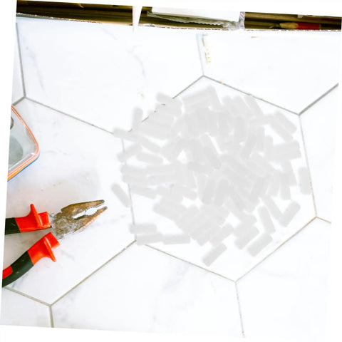 100 Pcs Nylon Hidden Fasteners And Double Headed Furniture Connectors on a tile surface with pliers, ideal for DIY builds.